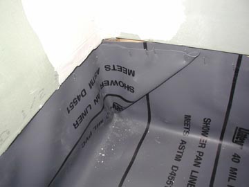 folding corners of a waterproof liner to avoid shower leaking
