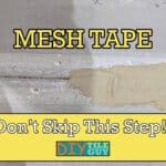 Mesh tape sits across a seam in between two sheet of cement board and is partially filled with thinset mortar