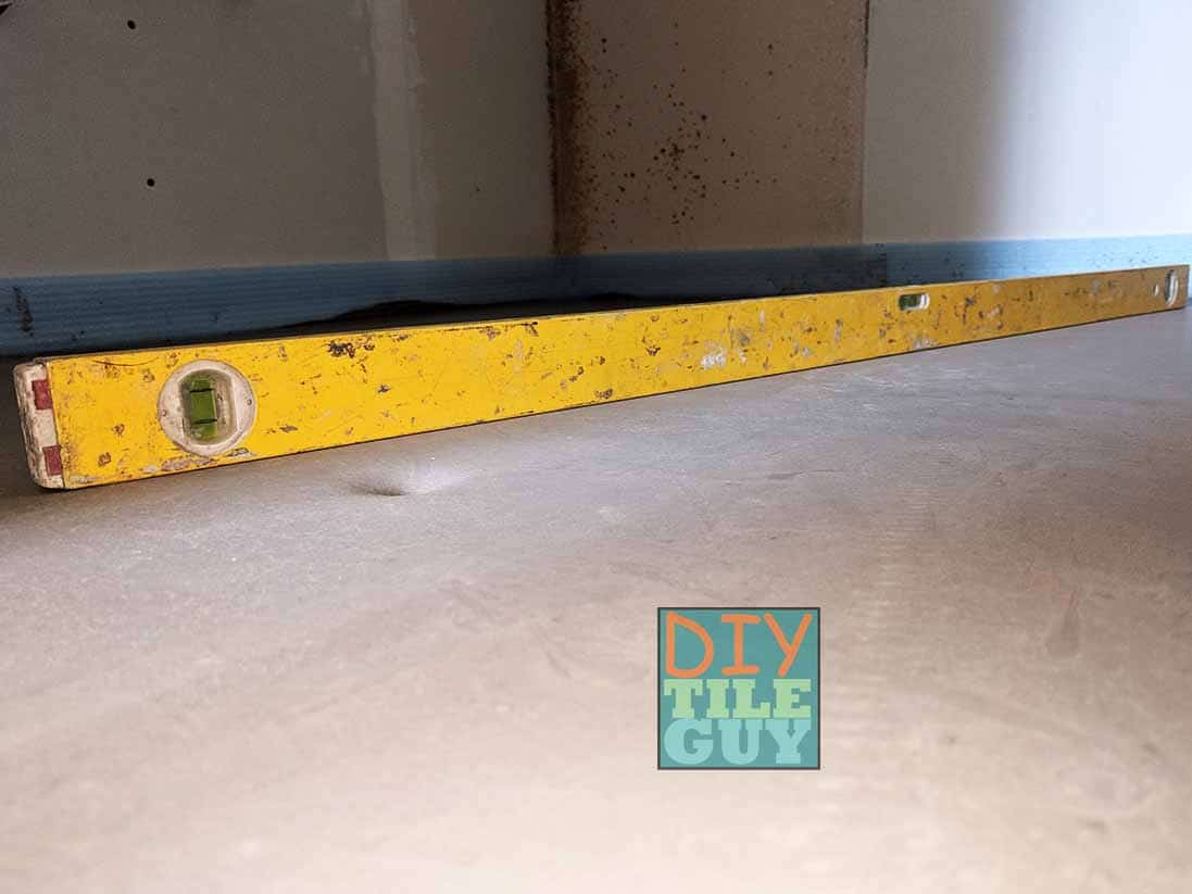 Checking a self-leveling pour with a level