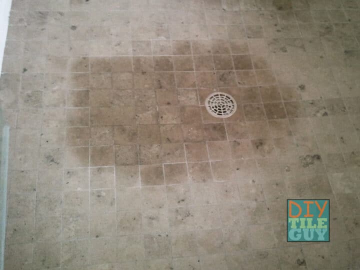 dark spot on marble shower floor