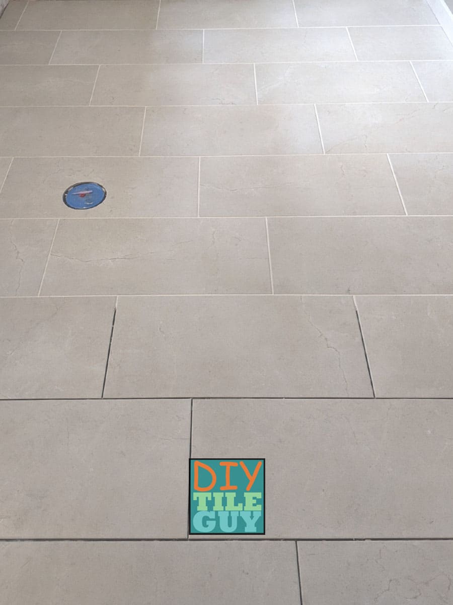 Rectangular tiles laid on a floor in a 33% offset tile pattern that stairsteps from right to left