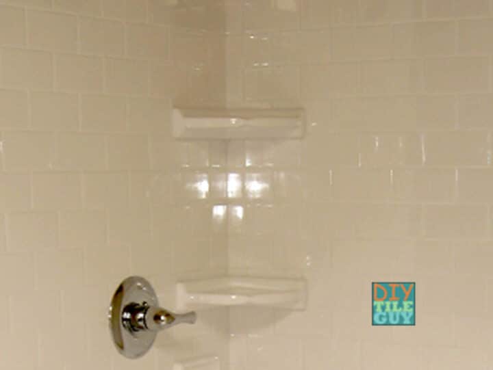 two ceramic corner shelves in a shower