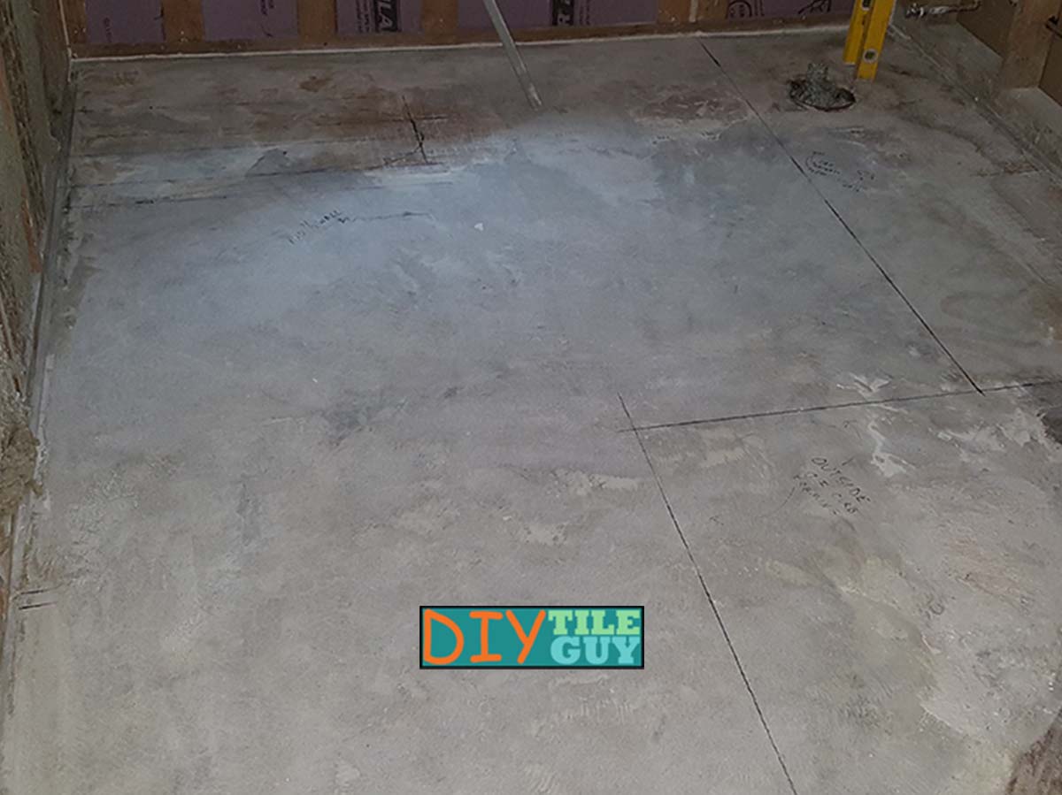 a bare and unfinished concrete basement subfloor