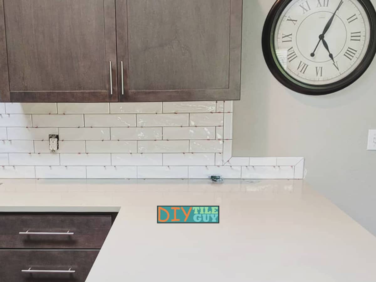 does the tile end? at the countertop or the cabinet?