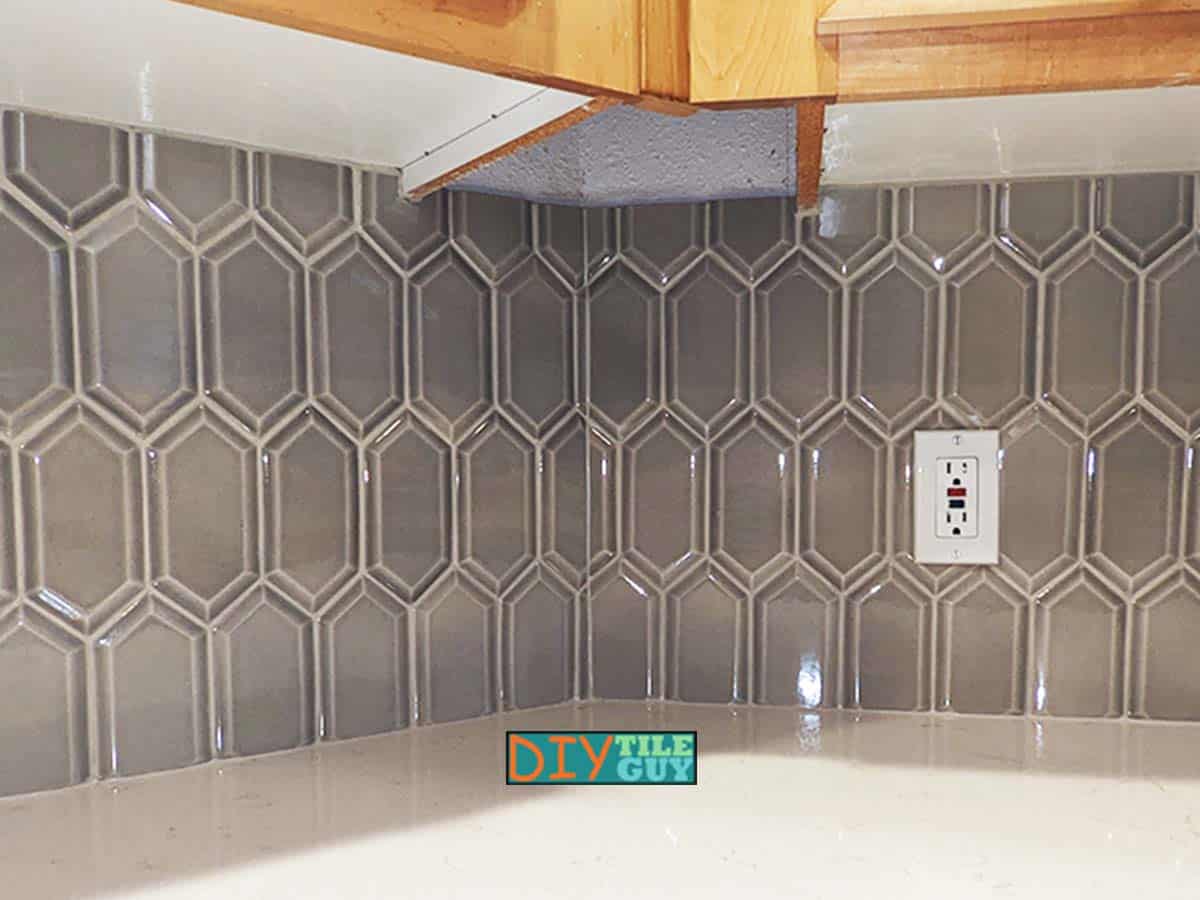 picket tile pattern is folding around an inside corner of a backsplash