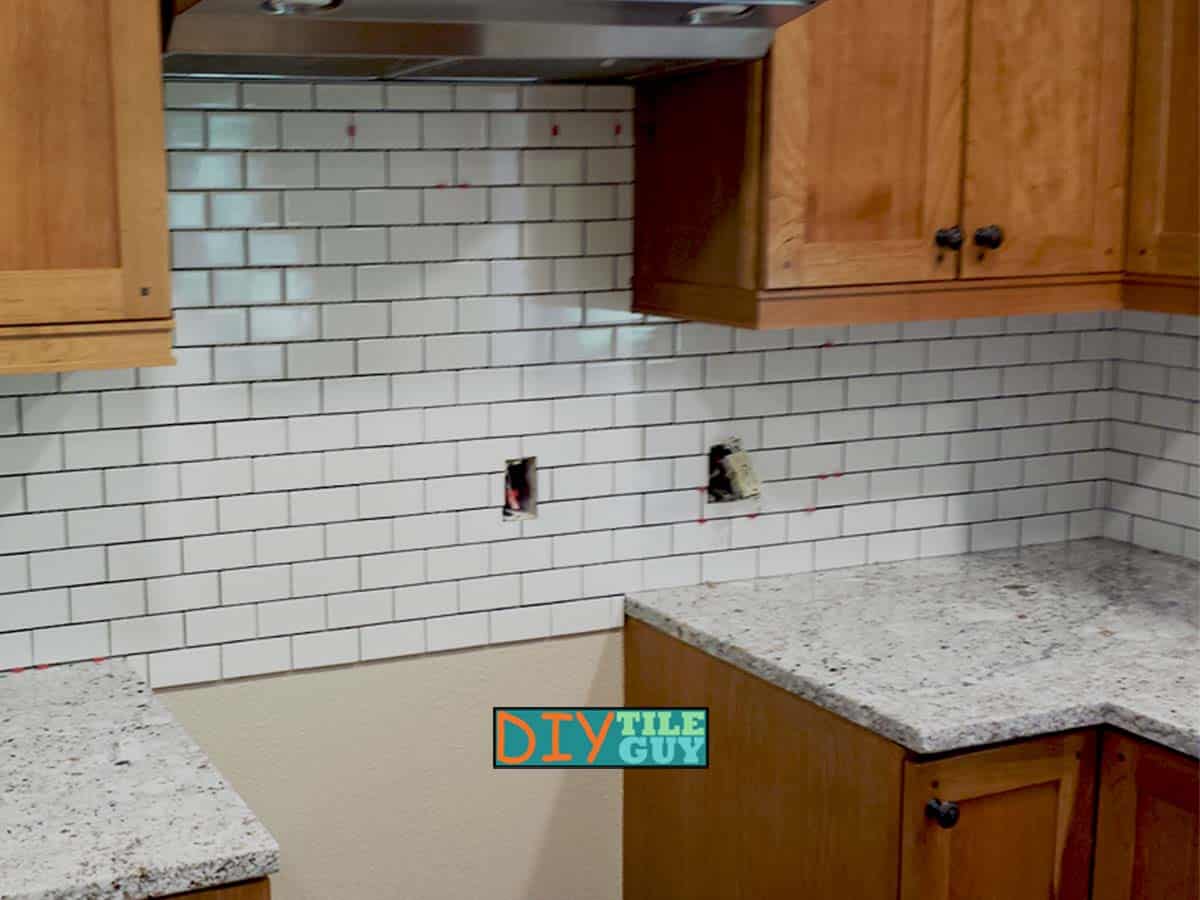tile extends below countertop level behind the stove